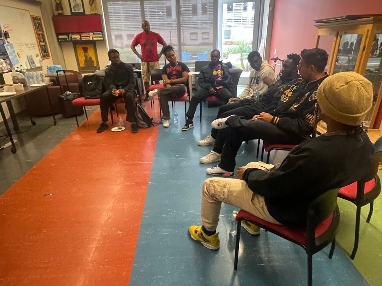 A group of student attendees in conversation during OBSD's event Black Men's Barbershop Talk Series at the AdCRC.