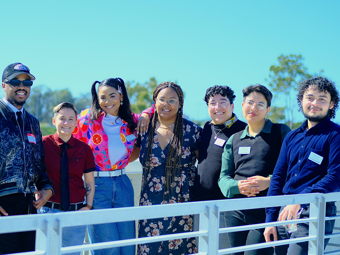 OBSD staff members Mekhi Mitchell, Angela Cantu, and Ashlee Preistley, posing for a group picture with RCSGD staff members Quinn Rioz, Marco Muñoz, Sky Limon, and Alex Elezar during the queer-centered event, Black QTea Party.